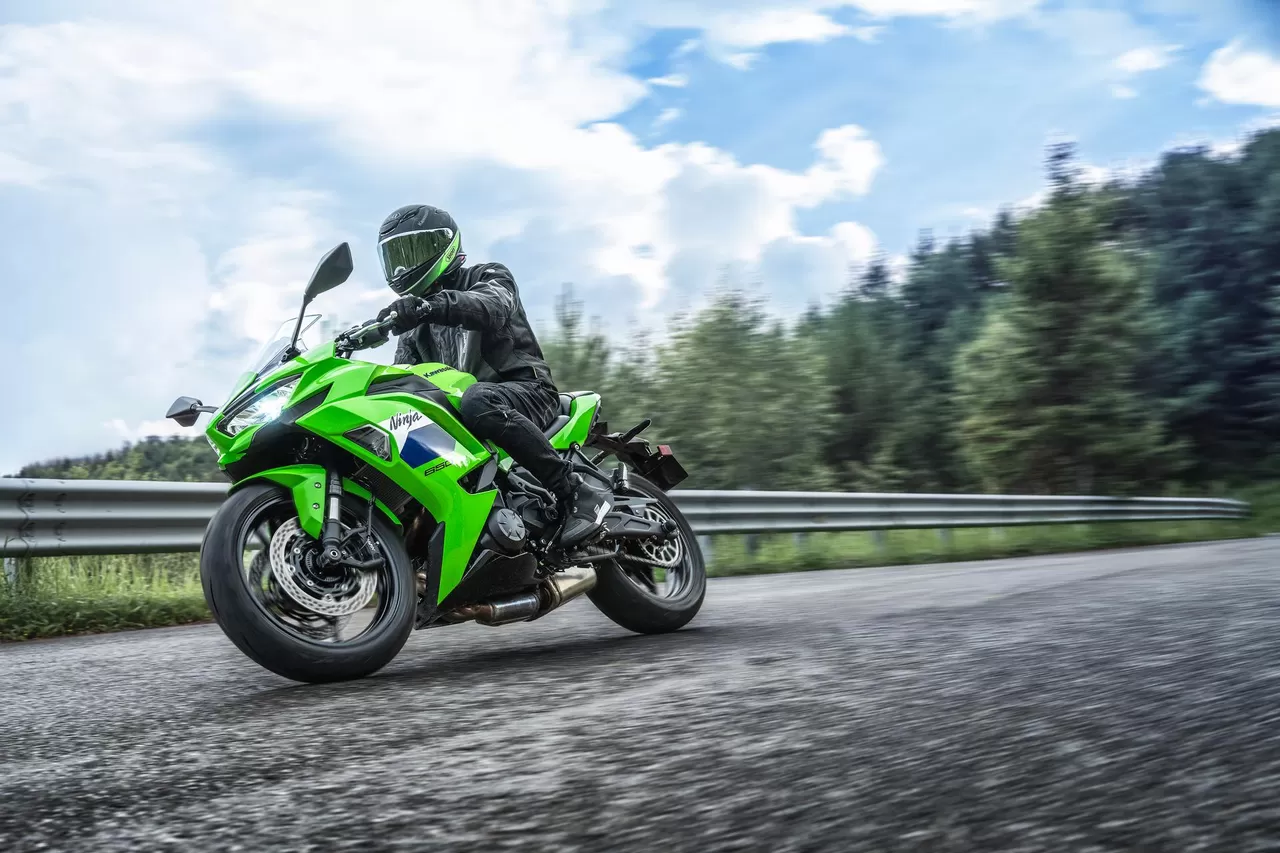 Rider on a Lime Green 2027 Kawasaki Ninja 650 on a country road